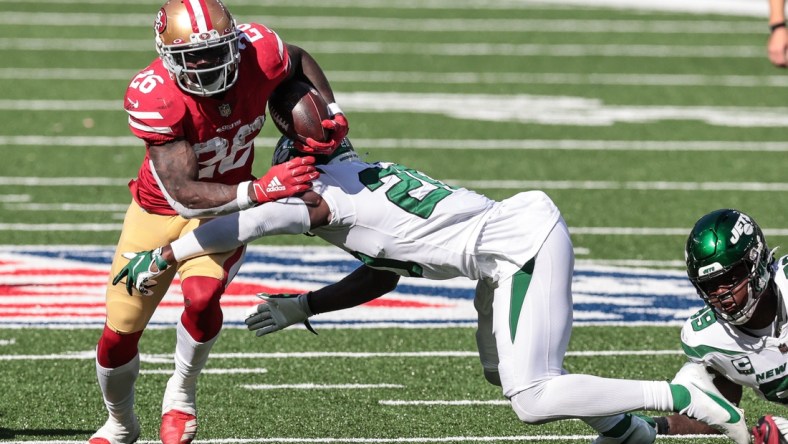 Sep 20, 2020; East Rutherford, New Jersey, USA; San Francisco 49ers running back Tevin Coleman (26) carries the ball as New York Jets free safety Marcus Maye (20) tackles during the second half at MetLife Stadium. Mandatory Credit: Vincent Carchietta-USA TODAY Sports