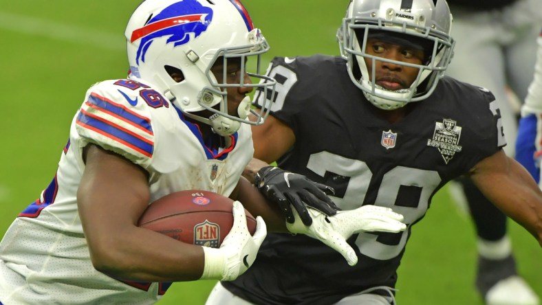 Oct 4, 2020; Paradise, Nevada, USA; Buffalo Bills running back Devin Singletary (26) looks to run past Las Vegas Raiders free safety Lamarcus Joyner (29) during the third quarter at Allegiant Stadium. Mandatory Credit: Stephen R. Sylvanie-USA TODAY Sports