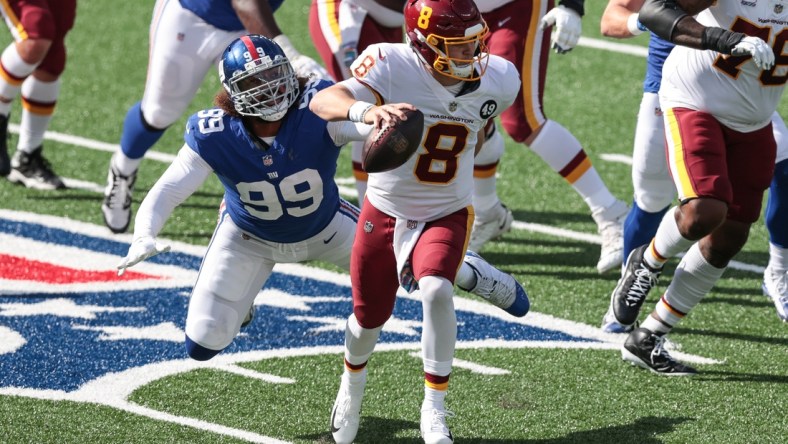 Oct 18, 2020; East Rutherford, New Jersey, USA; Washington Football Team quarterback Kyle Allen (8) scrambles as New York Giants defensive end Leonard Williams (99) pursues during the first half at MetLife Stadium. Mandatory Credit: Vincent Carchietta-USA TODAY Sports