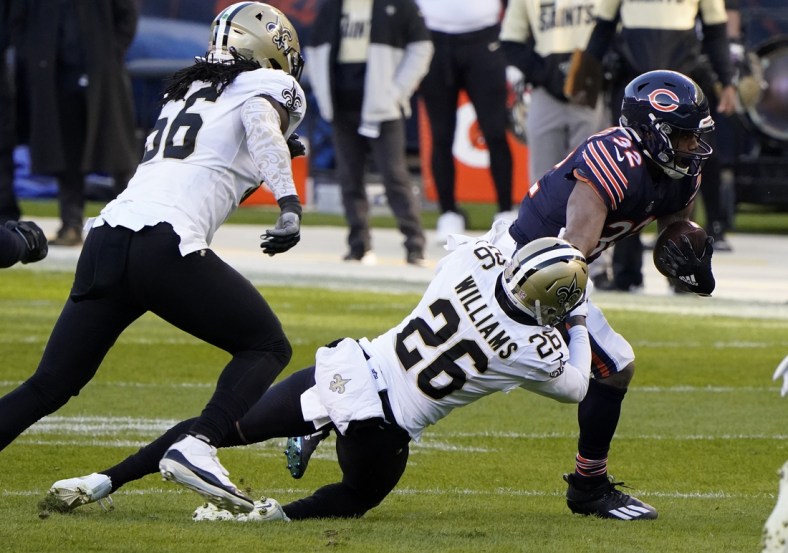 Nov 1, 2020; Chicago, Illinois, USA; Chicago Bears running back David Montgomery (32) breaks the tackle of New Orleans Saints cornerback P.J. Williams (26) during the first quarter at Soldier Field. Mandatory Credit: Mike Dinovo-USA TODAY Sports