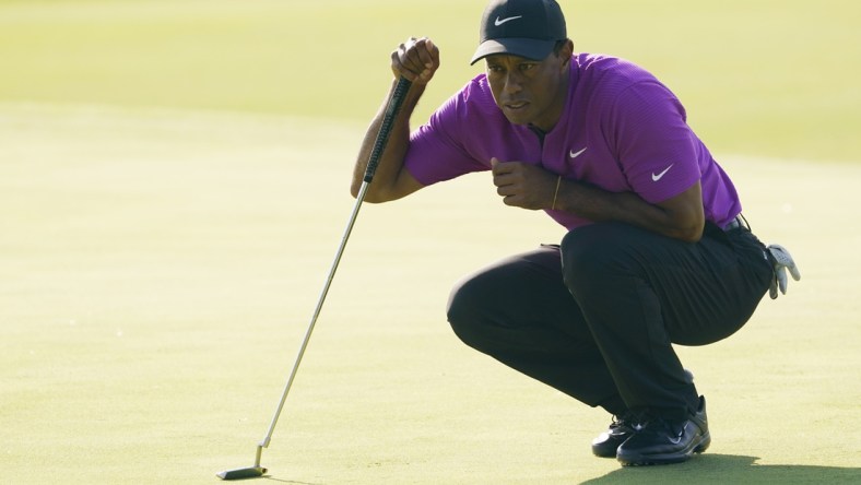 Nov 14, 2020; Augusta, Georgia, USA; Tiger Woods lines up his putt on the 17th green during the third round of The Masters golf tournament at Augusta National GC. Mandatory Credit: Michael Madrid-USA TODAY Sports