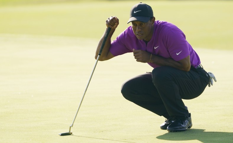 Nov 14, 2020; Augusta, Georgia, USA; Tiger Woods lines up his putt on the 17th green during the third round of The Masters golf tournament at Augusta National GC. Mandatory Credit: Michael Madrid-USA TODAY Sports