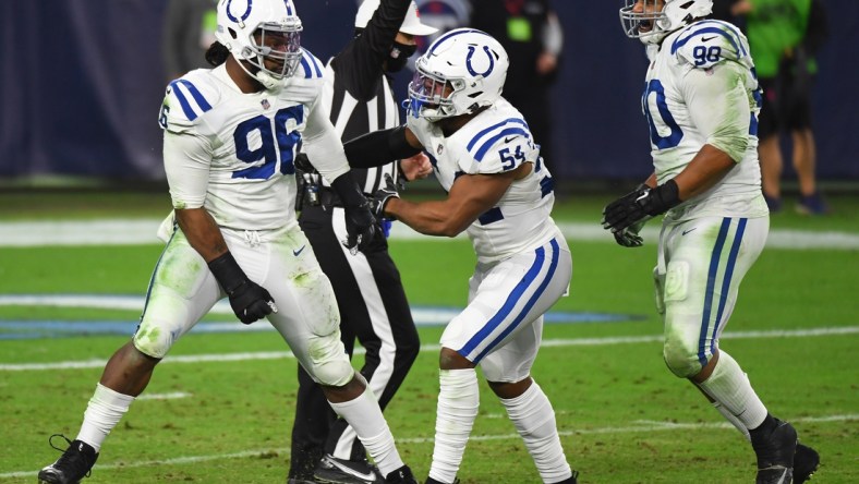 Nov 12, 2020; Nashville, Tennessee, USA; Indianapolis Colts defensive tackle Denico Autry (96) celebrates a sack with Indianapolis Colts middle linebacker Anthony Walker (54) and Indianapolis Colts defensive tackle Grover Stewart (90) during the second half against the Tennessee Titans at Nissan Stadium. Mandatory Credit: Christopher Hanewinckel-USA TODAY Sports