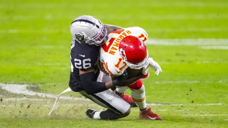 Nov 22, 2020; Paradise, Nevada, USA; Las Vegas Raiders cornerback Nevin Lawson (26) tackles Kansas City Chiefs wide receiver Mecole Hardman (17) at Allegiant Stadium. Mandatory Credit: Mark J. Rebilas-USA TODAY Sports