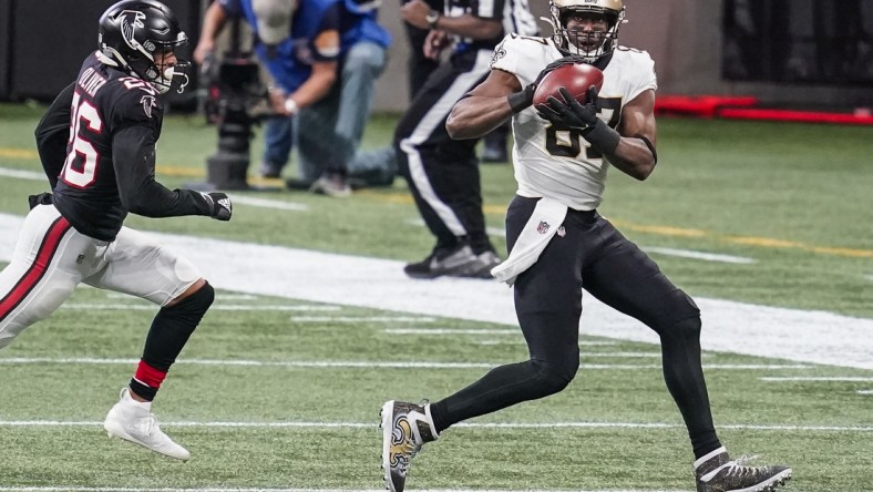 Dec 6, 2020; Atlanta, Georgia, USA; New Orleans Saints tight end Jared Cook (87) makes a catch in front of Atlanta Falcons cornerback Isaiah Oliver (26) during the second half at Mercedes-Benz Stadium. Mandatory Credit: Dale Zanine-USA TODAY Sports