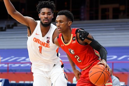 Dec 16, 2020; Syracuse, New York, USA; Northeastern Huskies guard Tyson Walker (2) drives to the basket against the defense of Syracuse Orange forward Quincy Guerrier (1) during the second half at the Carrier Dome. Mandatory Credit: Rich Barnes-USA TODAY Sports