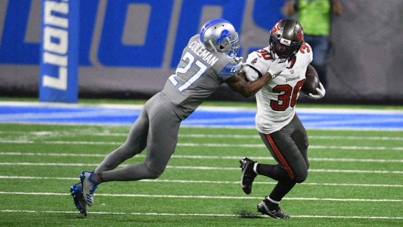 Dec 26, 2020; Detroit, Michigan, USA; Tampa Bay Buccaneers running back Ke Shawn Vaughn (30) runs the ball against Detroit Lions cornerback Justin Coleman (27) at Ford Field. Mandatory Credit: Tim Fuller-USA TODAY Sports