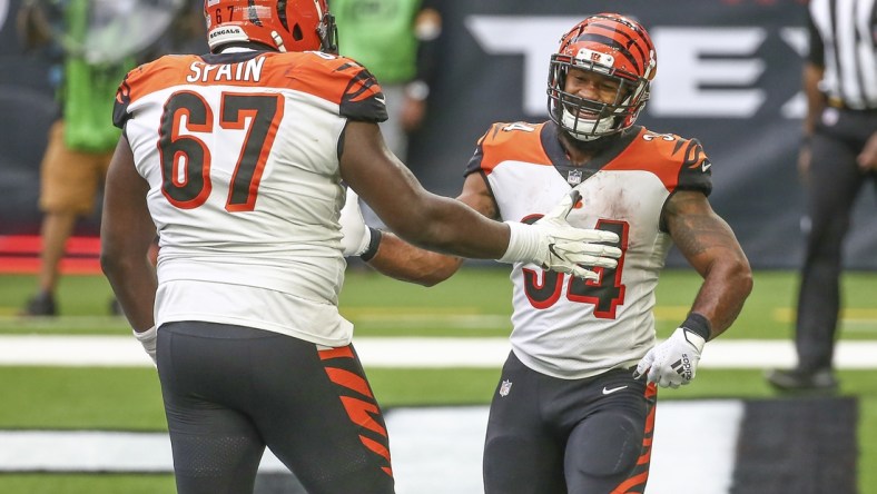 Dec 27, 2020; Houston, Texas, USA; Cincinnati Bengals running back Samaje Perine (34) celebrates with offensive guard Quinton Spain (67) after scoring a touchdown against the Houston Texans during the fourth quarter at NRG Stadium. Mandatory Credit: Troy Taormina-USA TODAY Sports