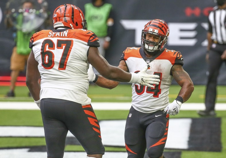 Dec 27, 2020; Houston, Texas, USA; Cincinnati Bengals running back Samaje Perine (34) celebrates with offensive guard Quinton Spain (67) after scoring a touchdown against the Houston Texans during the fourth quarter at NRG Stadium. Mandatory Credit: Troy Taormina-USA TODAY Sports