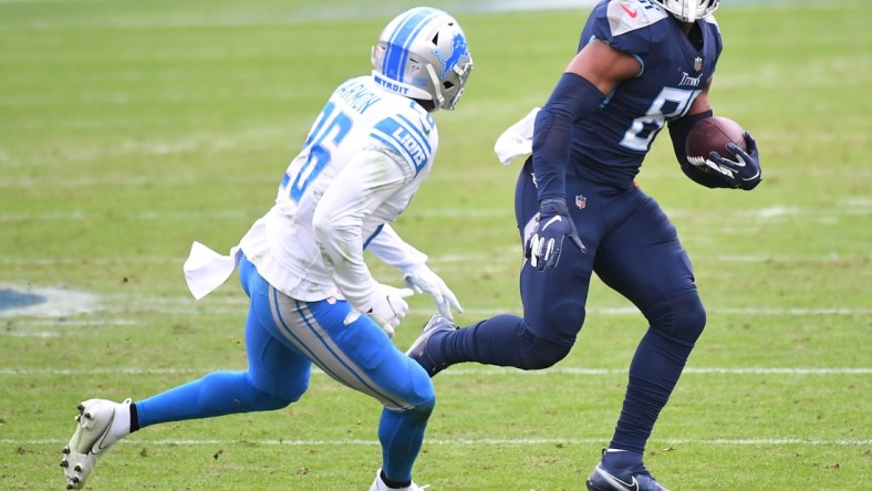 Dec 20, 2020; Nashville, Tennessee, USA; Tennessee Titans tight end Jonnu Smith (81) runs after a catch before being hit by Detroit Lions strong safety Duron Harmon (26) during the first half at Nissan Stadium. Mandatory Credit: Christopher Hanewinckel-USA TODAY Sports