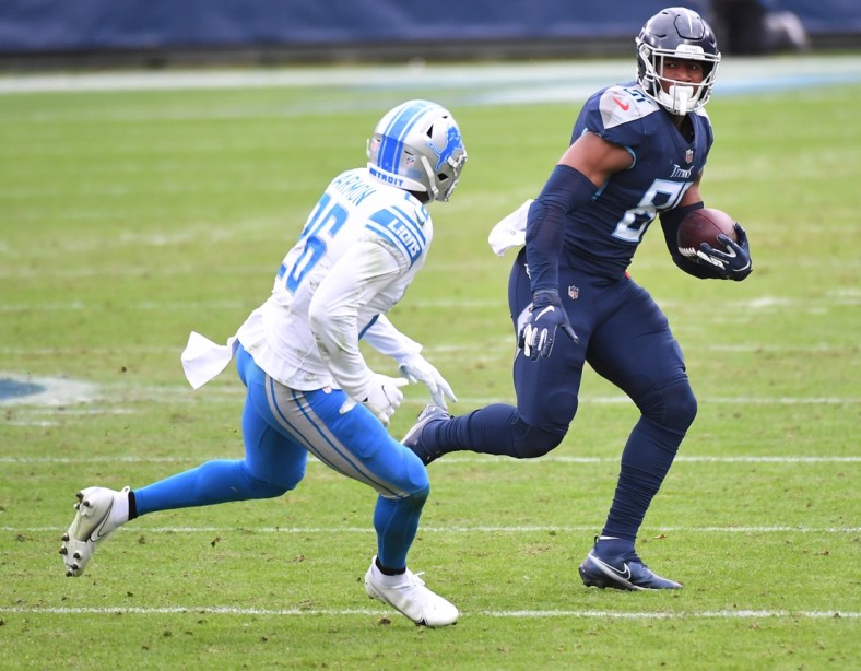 Dec 20, 2020; Nashville, Tennessee, USA; Tennessee Titans tight end Jonnu Smith (81) runs after a catch before being hit by Detroit Lions strong safety Duron Harmon (26) during the first half at Nissan Stadium. Mandatory Credit: Christopher Hanewinckel-USA TODAY Sports