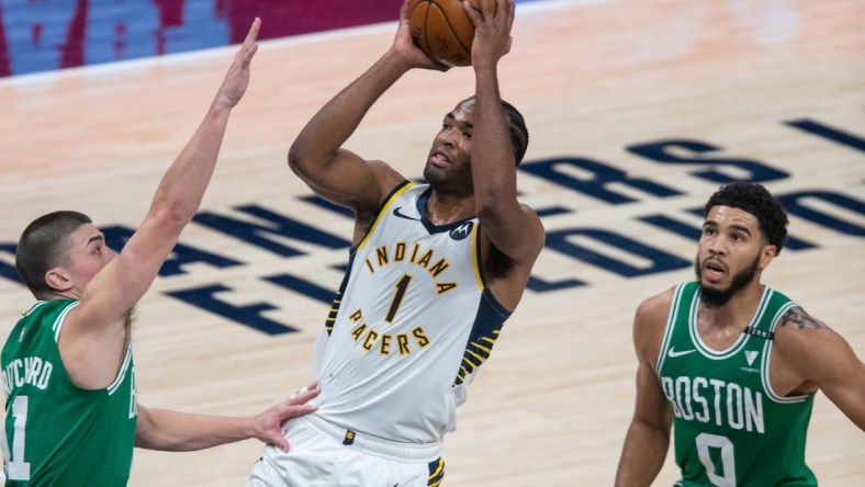 Dec 29, 2020; Indianapolis, Indiana, USA; Indiana Pacers forward T.J. Warren (1) shoots the ball against Boston Celtics forward Amile Jefferson (11) in the third quarter at Bankers Life Fieldhouse. Mandatory Credit: Trevor Ruszkowski-USA TODAY Sports