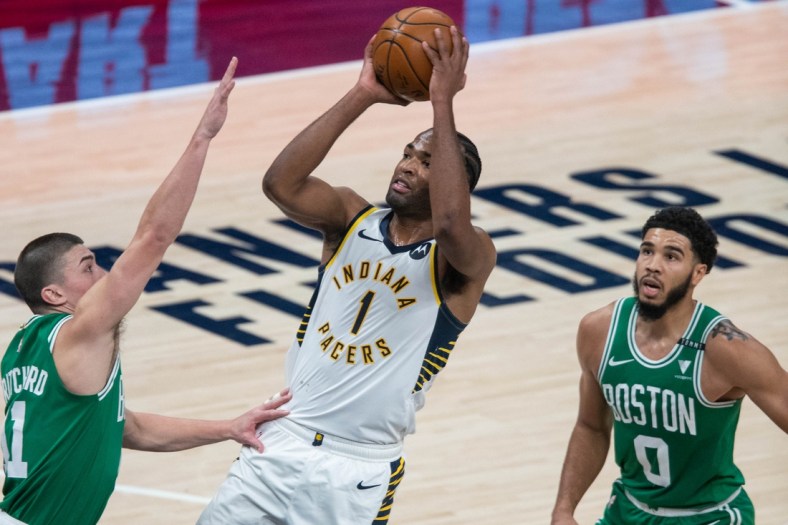 Dec 29, 2020; Indianapolis, Indiana, USA; Indiana Pacers forward T.J. Warren (1) shoots the ball against Boston Celtics forward Amile Jefferson (11) in the third quarter at Bankers Life Fieldhouse. Mandatory Credit: Trevor Ruszkowski-USA TODAY Sports