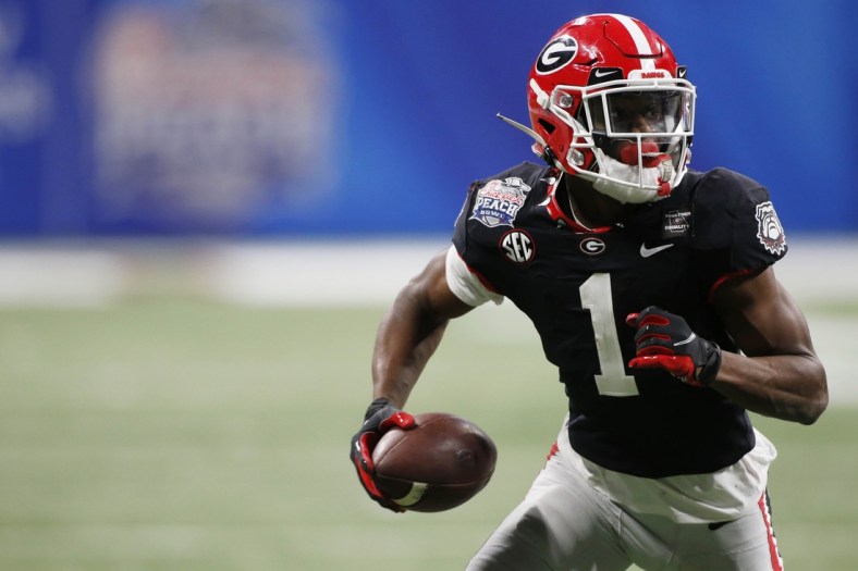 Jan 1, 2021; Atlanta, GA, USA; Georgia wide receiver George Pickens (1) moves the ball after pulling in a pass from Georgia quarterback JT Daniels (18) during the second half of the Peach Bowl NCAA college football game between Georgia and Cincinnati at Mercedes-Benz Stadium in Atlanta., on Friday, Jan. 1, 2021.  Georgia won 24-21. Mandatory Credit: Joshua L. Jones-USA TODAY NETWORK
