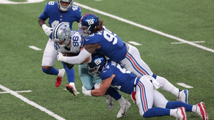 Jan 3, 2021; East Rutherford, NJ, USA; Dallas Cowboys tight end Dalton Schultz (86) is tackled by New York Giants defensive end Leonard Williams (99) and inside linebacker Blake Martinez (54) in the first half at MetLife Stadium. Mandatory Credit: Vincent Carchietta-USA TODAY Sports