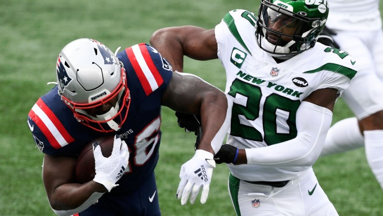 Jan 3, 2021; Foxborough, Massachusetts, USA; New England Patriots running back Sony Michel (26) rushes against New York Jets free safety Marcus Maye (20) during the first quarter at Gillette Stadium. Mandatory Credit: Brian Fluharty-USA TODAY Sports