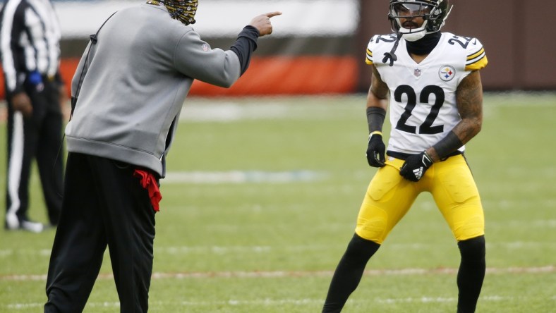 Jan 3, 2021; Cleveland, Ohio, USA; Pittsburgh Steelers head coach Mike Tomlin talks with cornerback Steven Nelson (22) during the first quarter against the Cleveland Browns at FirstEnergy Stadium. Mandatory Credit: Scott Galvin-USA TODAY Sports