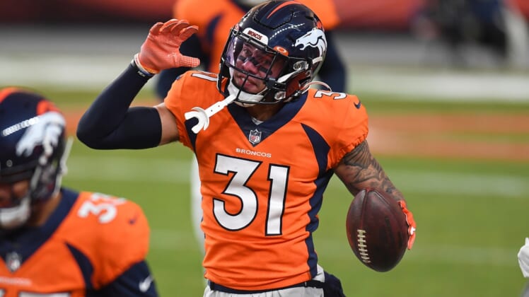Jan 3, 2021; Denver, Colorado, USA; Denver Broncos free safety Justin Simmons (31) celebrates his interception in the fourth quarter against the Las Vegas Raiders at Empower Field at Mile High. Mandatory Credit: Ron Chenoy-USA TODAY Sports