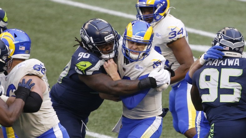 Jan 9, 2021; Seattle, Washington, USA; Seattle Seahawks defensive tackle Jarran Reed (90) sacks Los Angeles Rams quarterback Jared Goff (16) during the third quarter at Lumen Field. Mandatory Credit: Joe Nicholson-USA TODAY Sports