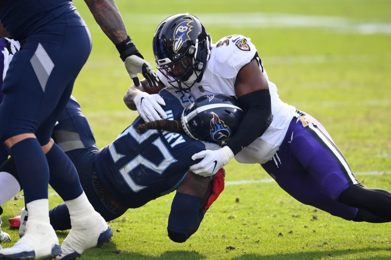 Jan 10, 2021; Nashville, Tennessee, USA; Tennessee Titans running back Derrick Henry (22) is tackled by Baltimore Ravens linebacker Tyus Bowser (54) during the third quarter in a AFC Wild Card playoff game at Nissan Stadium. Mandatory Credit: Christopher Hanewinckel-USA TODAY Sports
