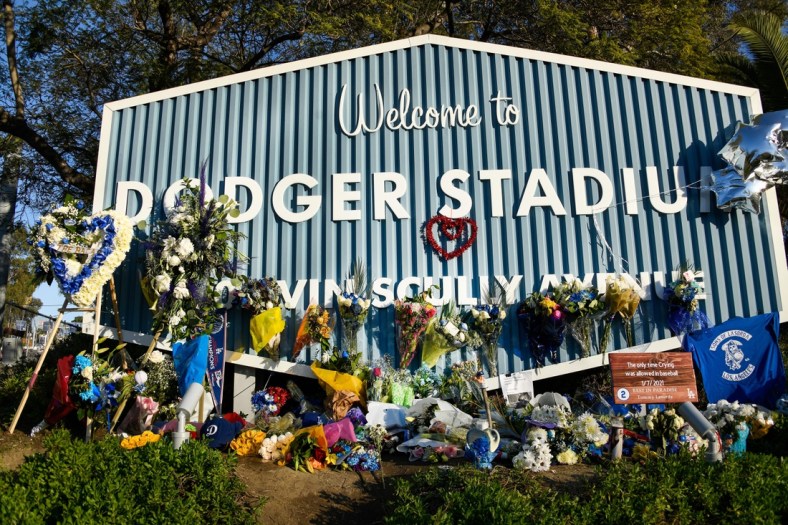 Jan 11, 2021; Los Angeles, California, USA; A makeshift memorial to Tommy Lasorda sprung up at the entrance to Dodger Stadium. The Hall of Fame Los Angeles Dodger manager  suffered heart failure at his Fullerton, Calif. home. He was 93. Lasorda won two World Series at the helm of the Dodgers in the 80's. Mandatory Credit: Robert Hanashiro-USA TODAY Sports