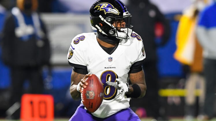 Jan 16, 2021; Orchard Park, New York, USA; Baltimore Ravens quarterback Lamar Jackson (8) drops back to pass against the Buffalo Bills during the first quarter of an AFC Divisional Round game at Bills Stadium. Mandatory Credit: Rich Barnes-USA TODAY Sports