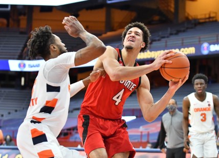 Jan 31, 2021; Syracuse, New York, USA; North Carolina State Wolfpack forward Jericole Hellems (4) looks to take a shot over the defense of Syracuse Orange forward Alan Griffin (0) in the second half at the Carrier Dome. Mandatory Credit: Mark Konezny-USA TODAY Sports