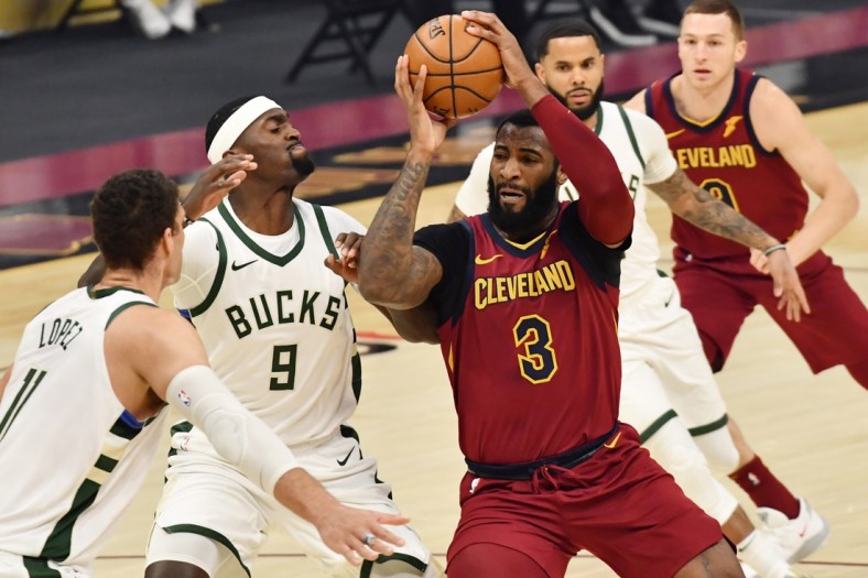 Feb 5, 2021; Cleveland, Ohio, USA; Cleveland Cavaliers center Andre Drummond (3) drives to the basket against Milwaukee Bucks center Bobby Portis (9) and center Brook Lopez (11) during the first quarter at Rocket Mortgage FieldHouse. Mandatory Credit: Ken Blaze-USA TODAY Sports