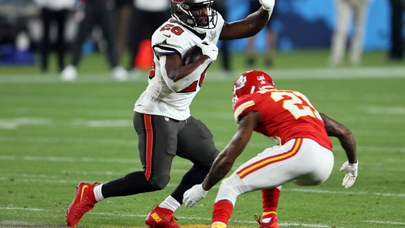 Feb 7, 2021; Tampa, FL, USA;  Tampa Bay Buccaneers running back Leonard Fournette (28) runs the ball against Kansas City Chiefs cornerback Bashaud Breeland (21) during the fourth quarter in Super Bowl LV at Raymond James Stadium.  Mandatory Credit: Matthew Emmons-USA TODAY Sports