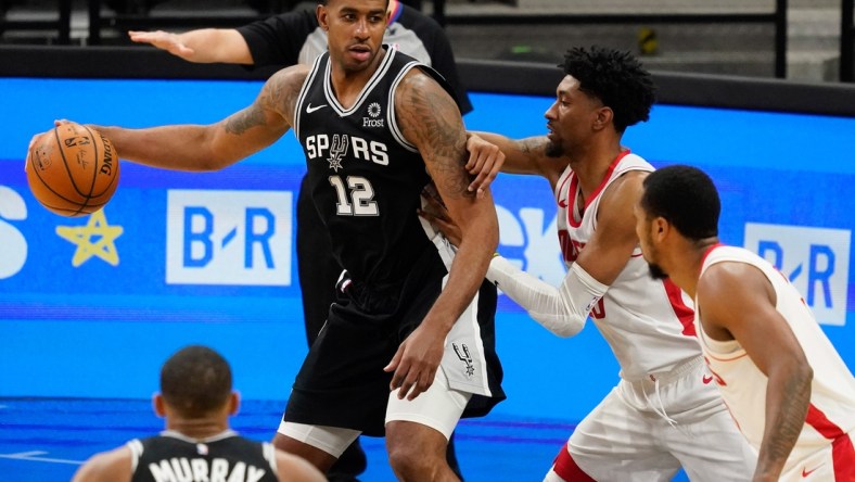 Jan 14, 2021; San Antonio, Texas, USA; San Antonio Spurs forward LaMarcus Aldridge (12) post up against Houston Rockets center Christian Wood (35) in the third quarter at AT&T Center. Mandatory Credit: Scott Wachter-USA TODAY Sports