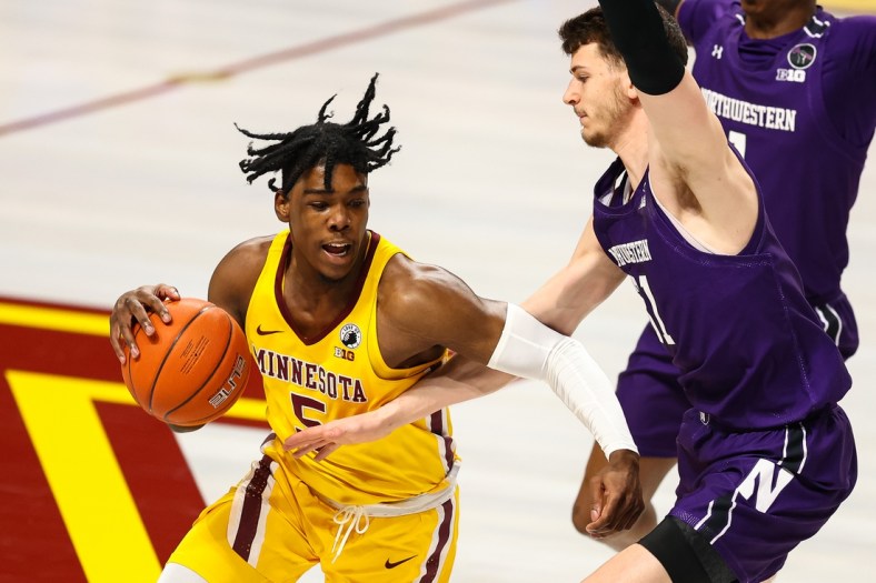 Feb 25, 2021; Minneapolis, Minnesota, USA; Minnesota Gophers guard Marcus Carr (5) drives to the basket as Northwestern Wildcats center Ryan Young (15) guards him during the first half at Williams Arena. Mandatory Credit: Harrison Barden-USA TODAY Sports