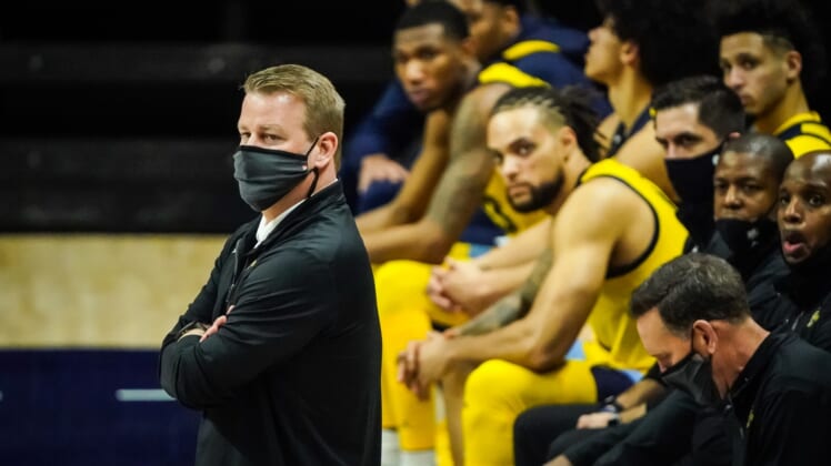 Feb 27, 2021; Storrs, Connecticut, USA; Marquette Golden Eagles head coach Steve Wojciechowski (left) watches from the sideline during the second half against the Connecticut Huskies at Harry A. Gampel Pavilion. UConn won 80-62. Mandatory Credit: David Butler II-USA TODAY Sports