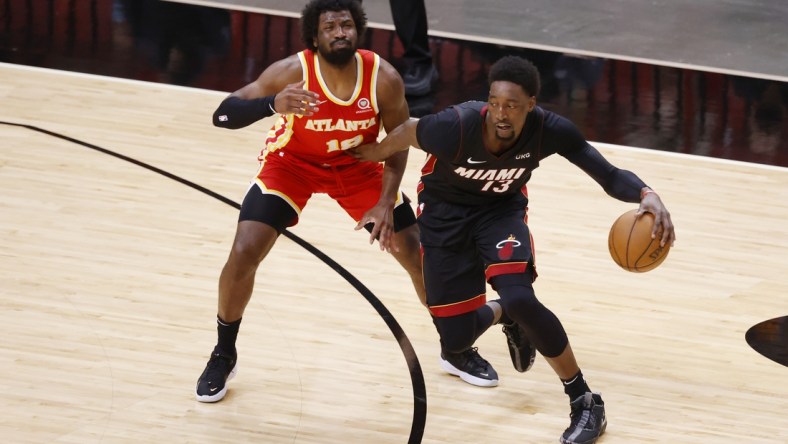 Feb 28, 2021; Miami, Florida, USA;   Atlanta Hawks forward Solomon Hill (18) defends Miami Heat center Bam Adebayo (13) during the first half at American Airlines Arena. Mandatory Credit: Rhona Wise-USA TODAY Sports