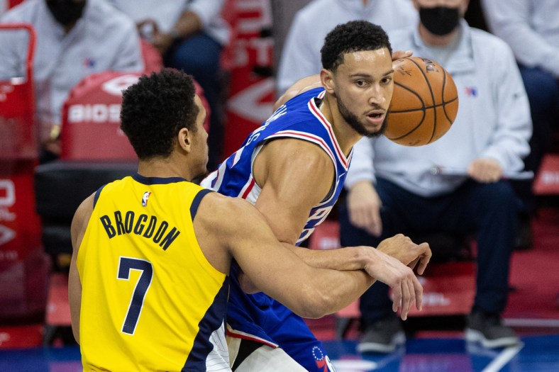 Mar 1, 2021; Philadelphia, Pennsylvania, USA; Philadelphia 76ers guard Ben Simmons (25) controls the ball against Indiana Pacers guard Malcolm Brogdon (7) during the first quarter at Wells Fargo Center. Mandatory Credit: Bill Streicher-USA TODAY Sports