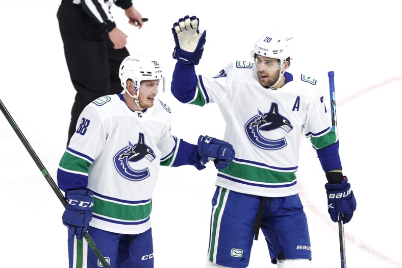 Mar 1, 2021; Winnipeg, Manitoba, CAN;  Vancouver Canucks defenseman Nate Schmidt (88) celebrates his first period goal with Vancouver Canucks center Brandon Sutter (20) against the Winnipeg Jets at Bell MTS Place. Mandatory Credit: James Carey Lauder-USA TODAY Sports