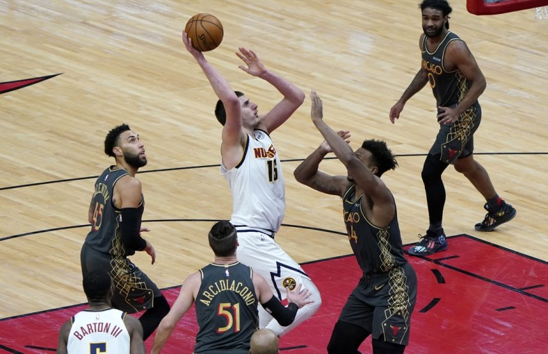 Mar 1, 2021; Chicago, Illinois, USA; Denver Nuggets center Nikola Jokic (15) shoots the ball over Chicago Bulls center Wendell Carter Jr. (34) during the fourth quarter at the United Center. Mandatory Credit: Mike Dinovo-USA TODAY Sports