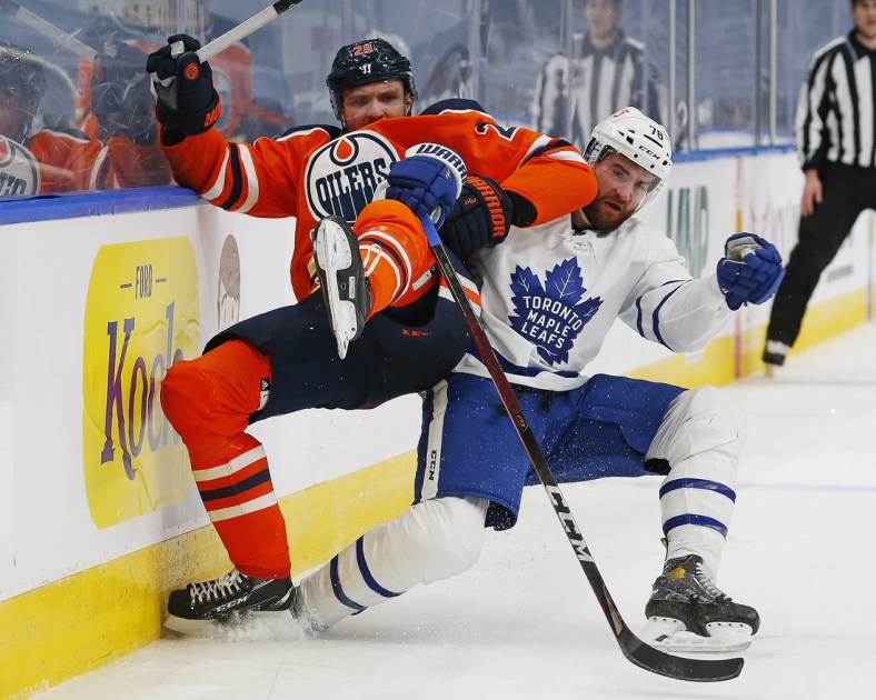Mar 1, 2021; Edmonton, Alberta, CAN; Toronto Maple Leafs defensemen T.J. Brodie (78) and Edmonton Oilers forward Leon Draisaitl (29) play for the puck during the third period at Rogers Place. Mandatory Credit: Perry Nelson-USA TODAY Sports