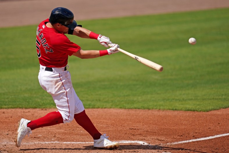 Mar 2, 2021; Fort Myers, Florida, USA; Boston Red Sox short stop Enrique Hernandez (5) connects for a solo homerun in the 3rd inning of the spring training game against the Tampa Bay Rays at JetBlue Park at Fenway South. Mandatory Credit: Jasen Vinlove-USA TODAY Sports