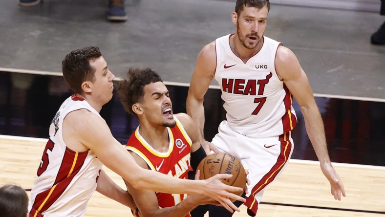 Mar 2, 2021; Miami, Florida, USA; Miami Heat forward Duncan Robinson (55) and guard Goarn Dragic (7) defend  Atlanta Hawks guard Trae Young (11) at American Airlines Arena. Mandatory Credit: Rhona Wise-USA TODAY Sports