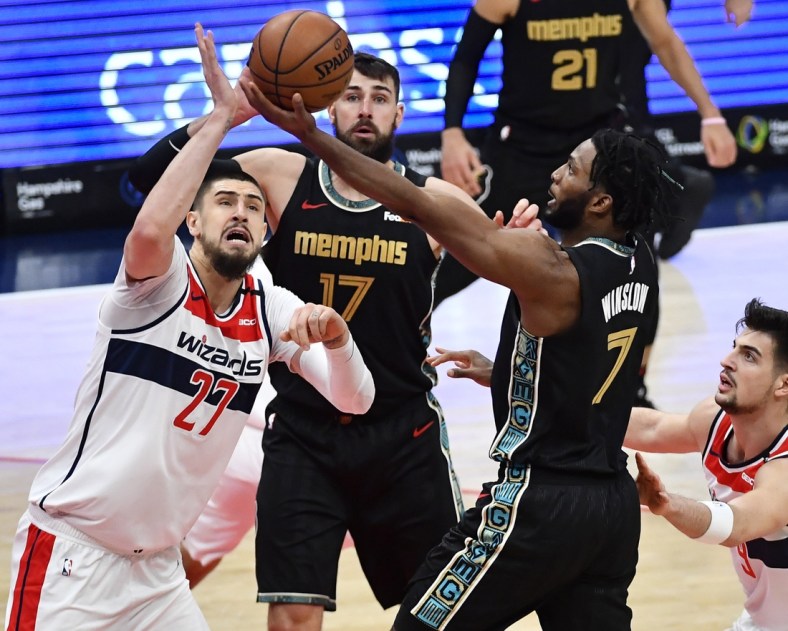 Mar 2, 2021; Washington, District of Columbia, USA; Memphis Grizzlies forward Justise Winslow (7) shoots the ball against Washington Wizards center Alex Len (27) during the second quarter at Capital One Arena. Mandatory Credit: Brad Mills-USA TODAY Sports