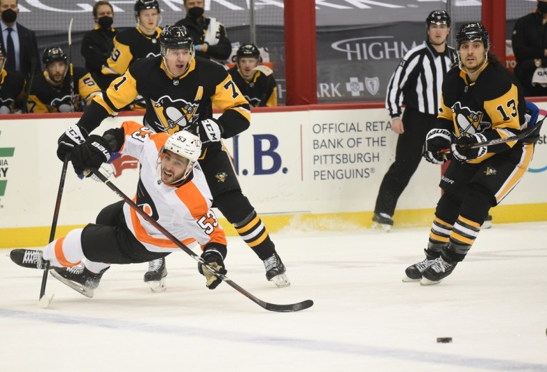 Mar 2, 2021; Pittsburgh, Pennsylvania, USA; Philadelphia Flyers defender Shayne Gostisbehere (53) is knocked down by Pittsburgh Penguins center Evgeni Malkin (71) during the first period at PPG Paints Arena. Mandatory Credit: Philip G. Pavely-USA TODAY Sports