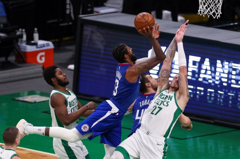 Mar 2, 2021; Boston, Massachusetts, USA; Los Angeles Clippers guard Paul George (13) shoots the ball over Boston Celtics center Daniel Theis (27) during the first half at TD Garden. Mandatory Credit: Paul Rutherford-USA TODAY Sports