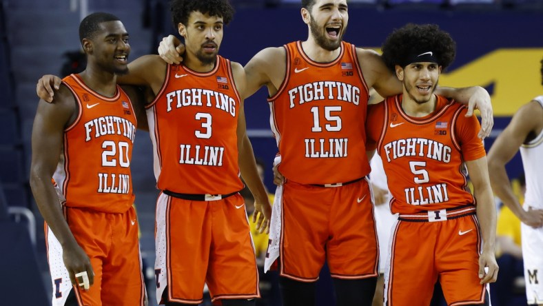 Mar 2, 2021; Ann Arbor, Michigan, USA;  Illinois Fighting Illini guard Da'Monte Williams (20) guard Jacob Grandison (3) forward Giorgi Bezhanishvili (15) and guard Andre Curbelo (5) react in the second half against the Michigan Wolverines at Crisler Center. Mandatory Credit: Rick Osentoski-USA TODAY Sports