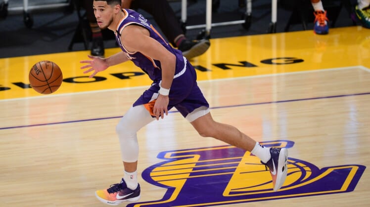 Mar 2, 2021; Los Angeles, California, USA; Phoenix Suns guard Devin Booker (1) moves the ball down court against the Los Angeles Lakers during the first half at Staples Center. Mandatory Credit: Gary A. Vasquez-USA TODAY Sports