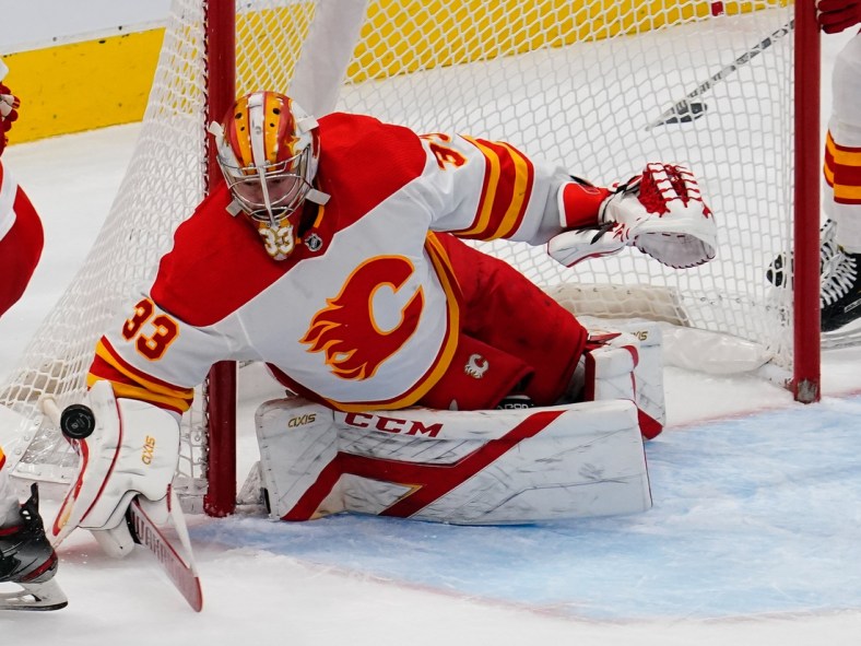 Feb 24, 2021; Toronto, Ontario, CAN; Calgary Flames goaltender David Rittich (33) makes a save against the Toronto Maple Leafs at Scotiabank Arena. Toronto defeated Calgary 2-1 in overtime. Mandatory Credit: John E. Sokolowski-USA TODAY Sports