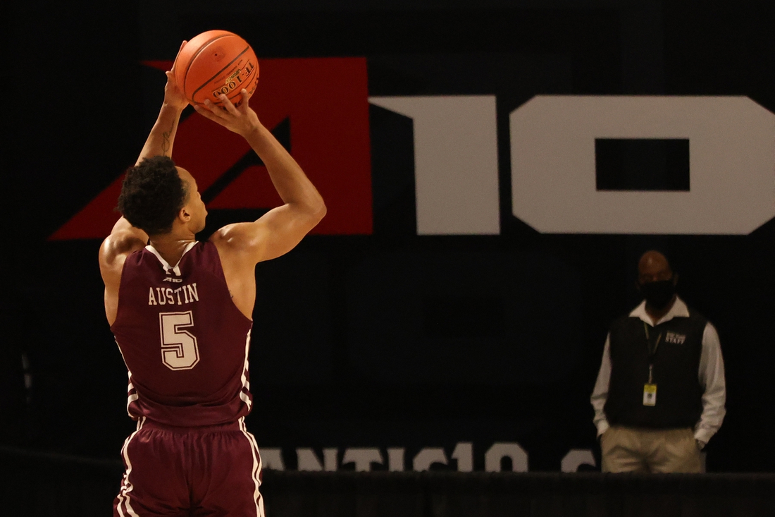 Mar 6, 2021; Richmond, Virginia, USA; Fordham Rams guard Chris Austin (5) shoots the ball against the George Washington Colonials in the first half in the first round of the 2021 Atlantic 10 Conference Tournament at at Stuart C. Siegel Center. Mandatory Credit: Geoff Burke-USA TODAY Sports