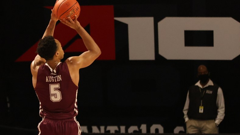 Mar 6, 2021; Richmond, Virginia, USA; Fordham Rams guard Chris Austin (5) shoots the ball against the George Washington Colonials in the first half in the first round of the 2021 Atlantic 10 Conference Tournament at at Stuart C. Siegel Center. Mandatory Credit: Geoff Burke-USA TODAY Sports