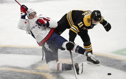 Mar 3, 2021; Boston, Massachusetts, USA; Boston Bruins center Trent Frederic (11) knocks down Washington Capitals right wing Tom Wilson (43) during the second period at TD Garden. Mandatory Credit: Winslow Townson-USA TODAY Sports