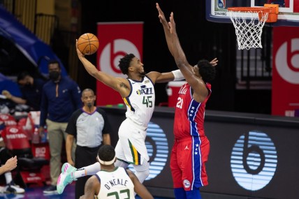 Mar 3, 2021; Philadelphia, Pennsylvania, USA; Utah Jazz guard Donovan Mitchell (45) is fouled while attempting to dunk against Philadelphia 76ers center Joel Embiid (21) during the third quarter at Wells Fargo Center. Mandatory Credit: Bill Streicher-USA TODAY Sports