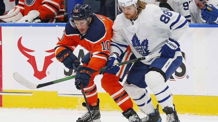Mar 3, 2021; Edmonton, Alberta, CAN; Toronto Maple Leafs forward William Nylander (88) and Edmonton Oilers forward Joakim Nygard (10) battle for a loose puck during the first period at Rogers Place. Mandatory Credit: Perry Nelson-USA TODAY Sports